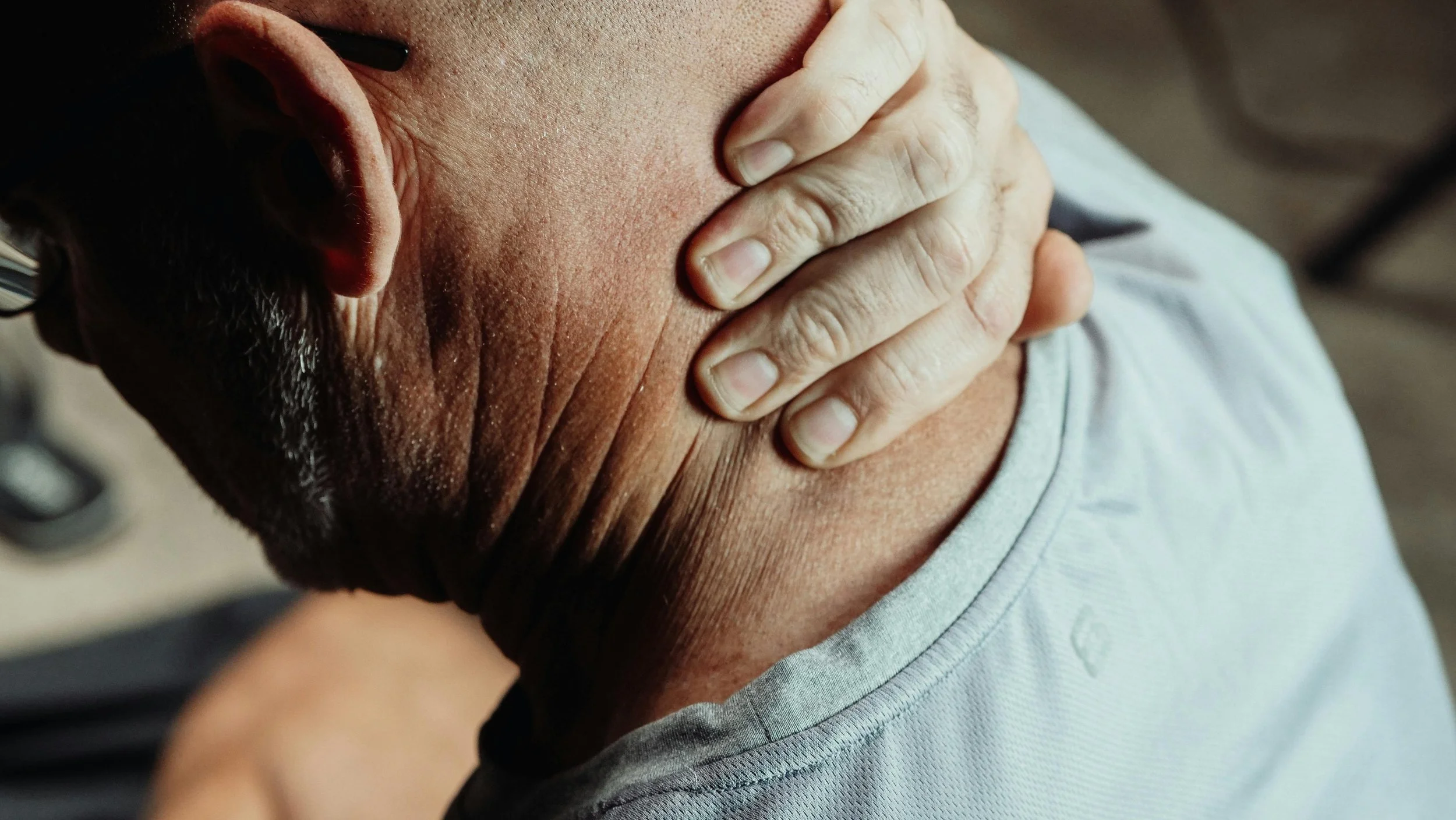 man holding back of his neck