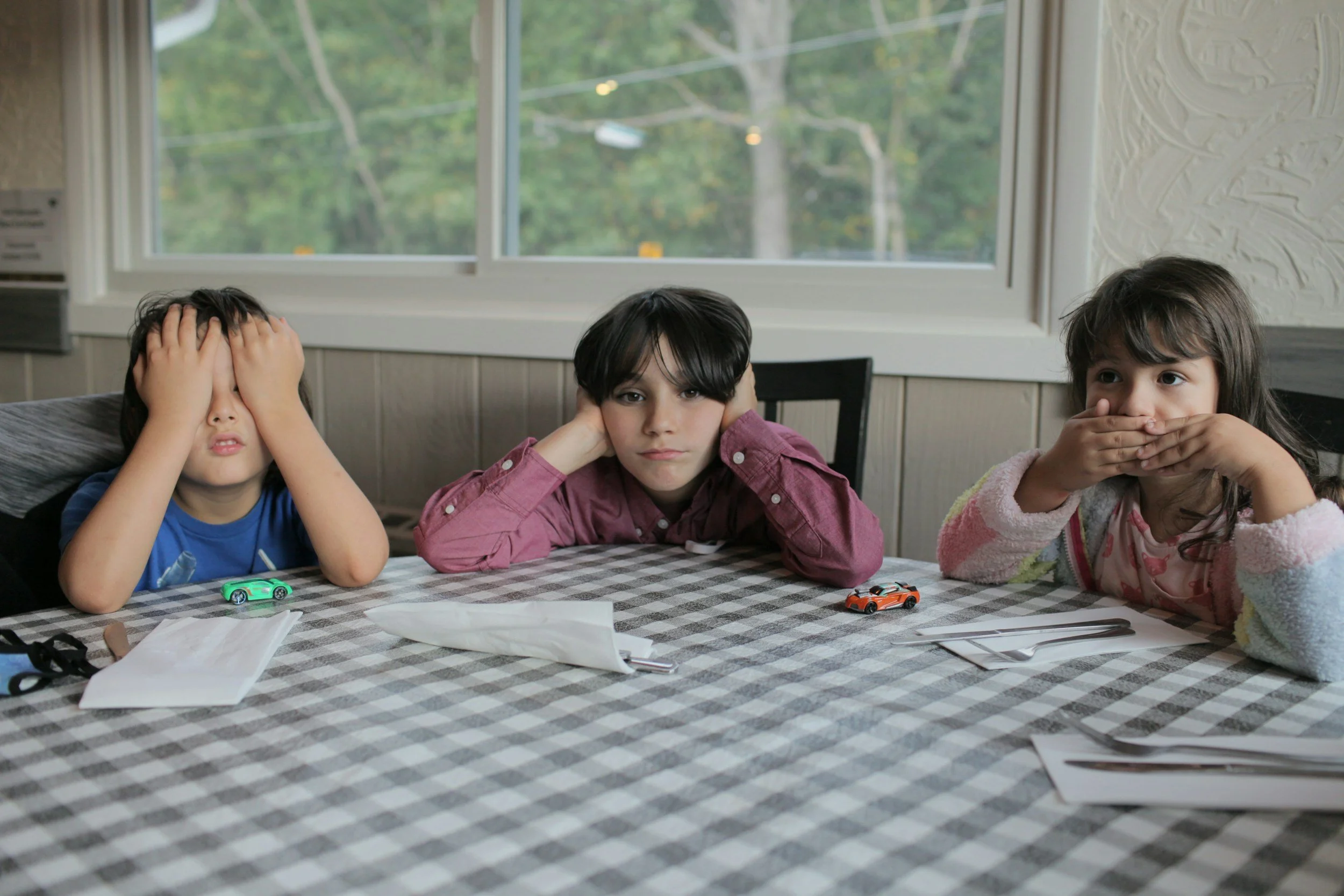 three kids doing see no evil, hear no evil and speak no evil