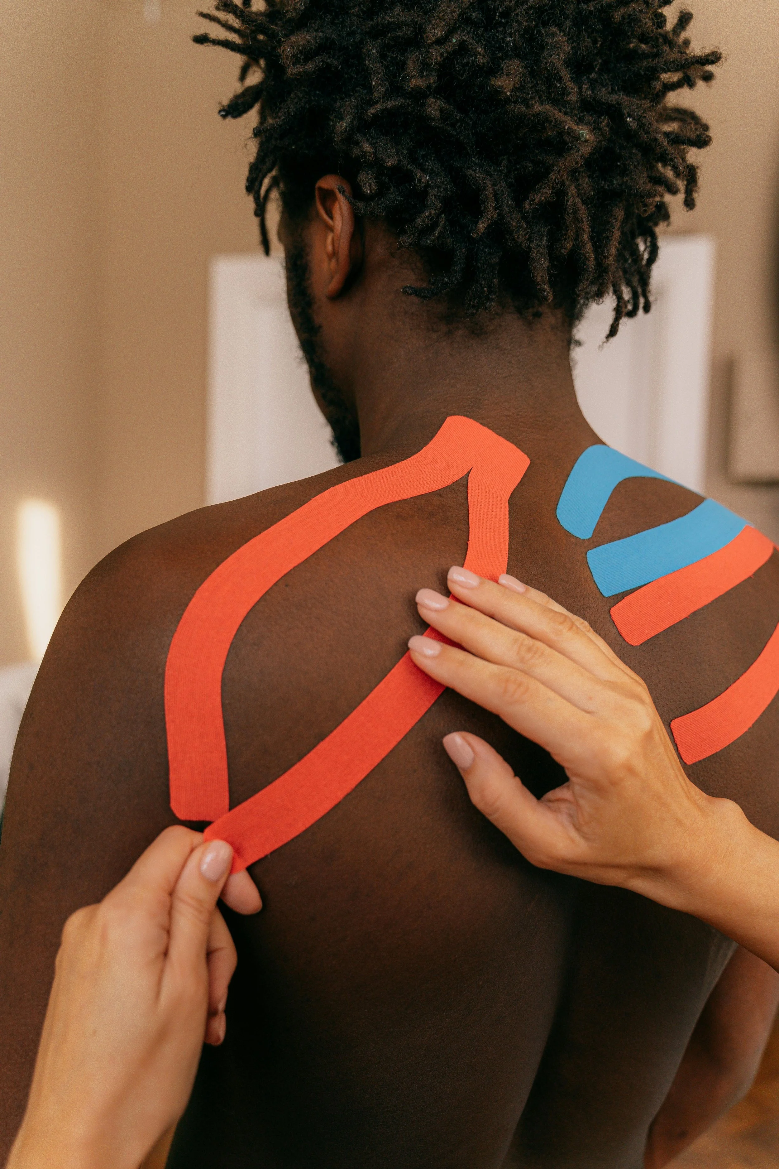 applying KT tape to a back