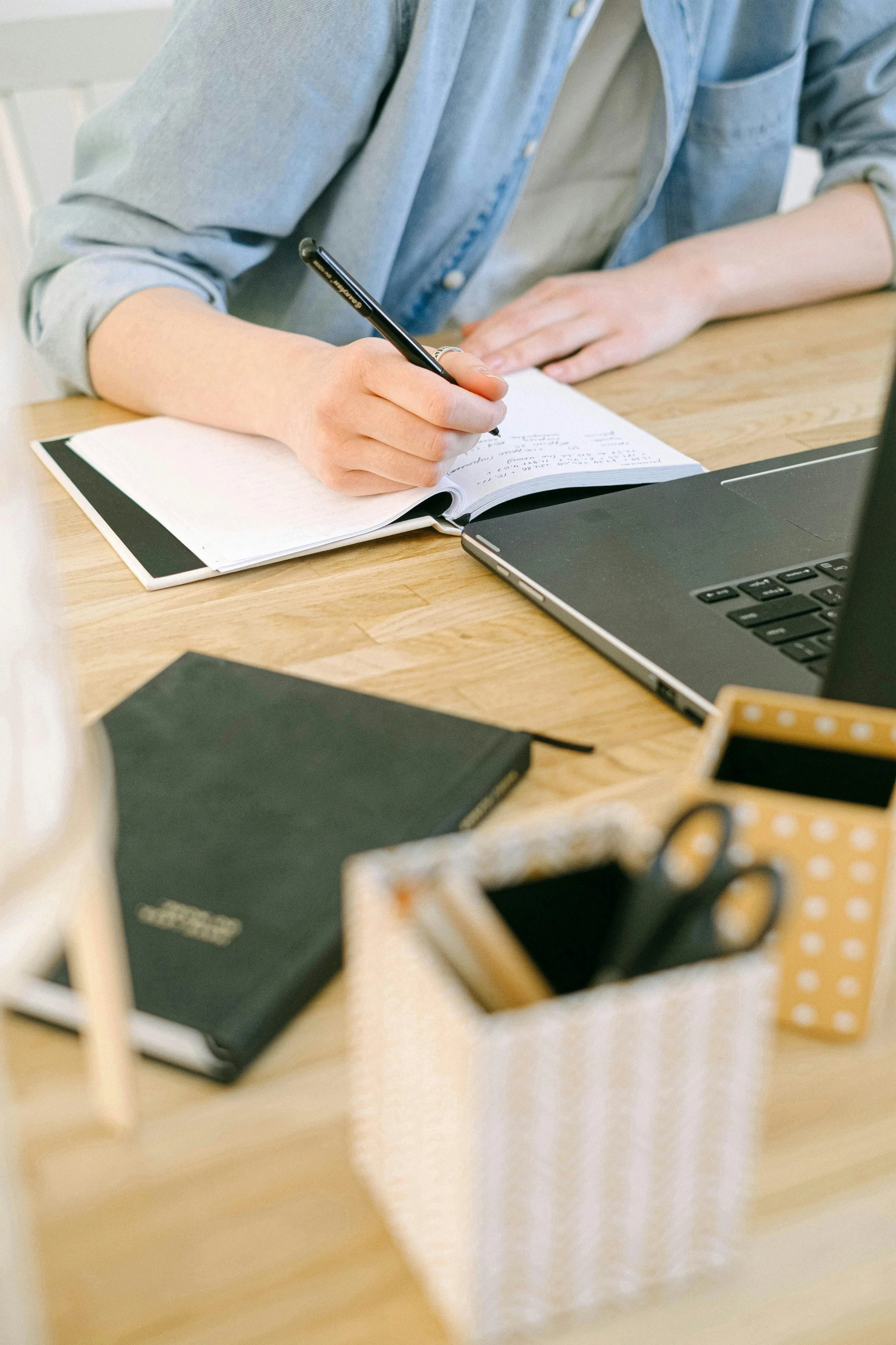 taking notes in front of a laptop