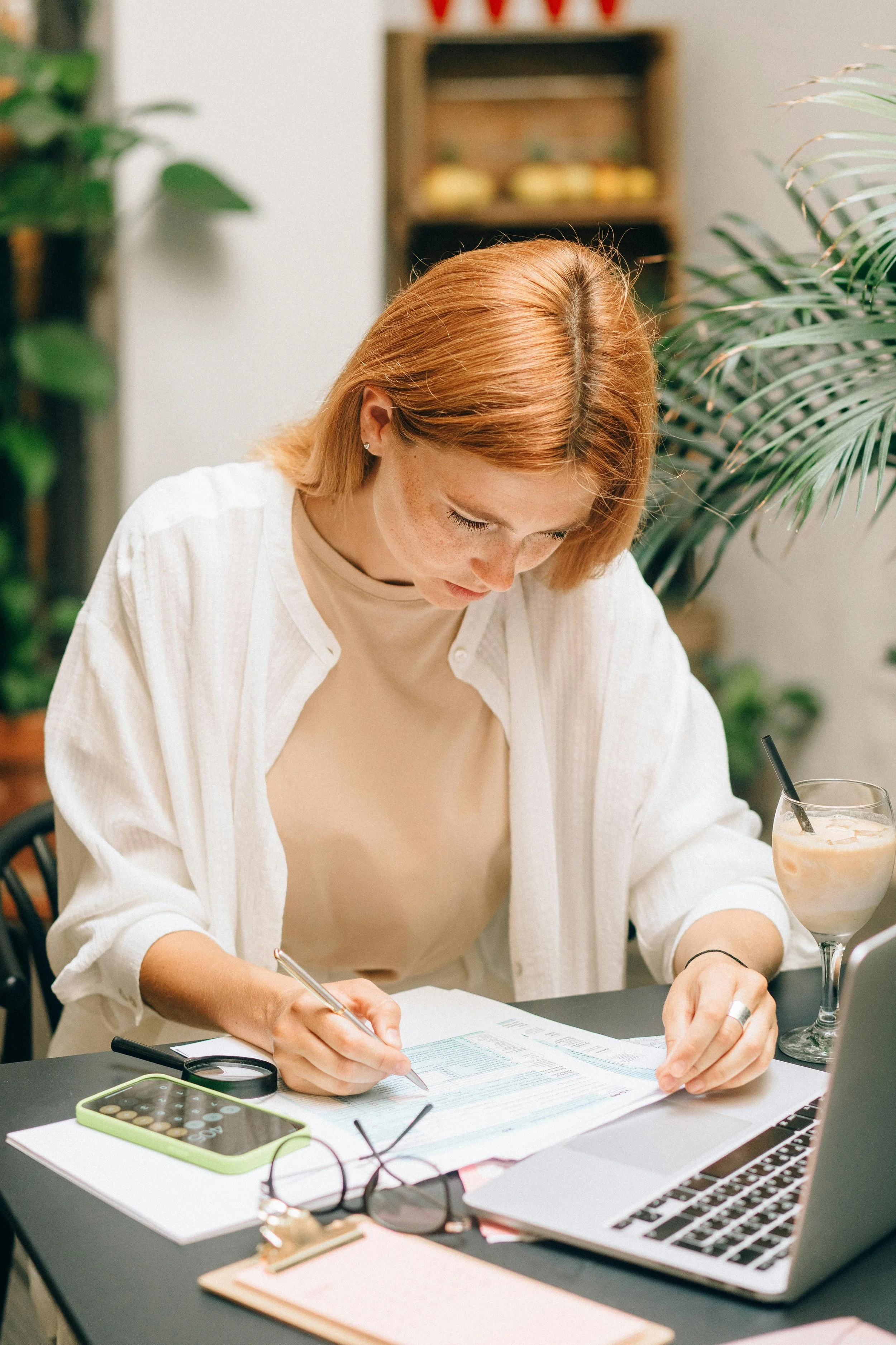 woman calculating money / benefits at a table